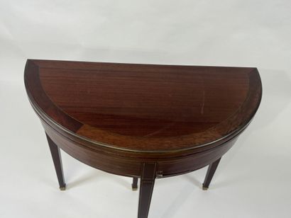 Mahogany veneered half-moon game table.
Louis...