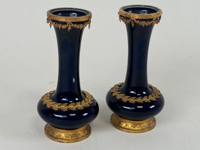A pair of blue earthenware vases, with chased...