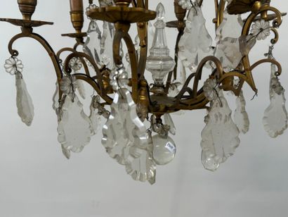 Six-arm bronze chandelier with crystal pendants.
H....