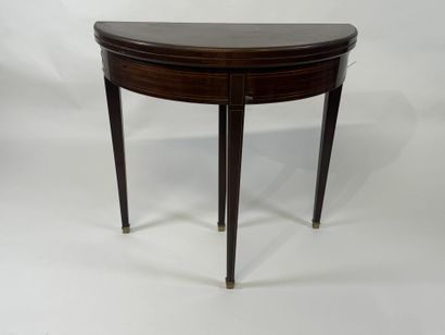 Mahogany veneered half-moon game table.
Louis...