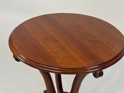 Circular cherrywood pedestal table with scrolls.
20th...