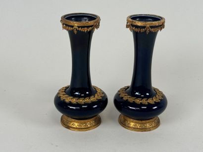 A pair of blue earthenware vases, with chased...