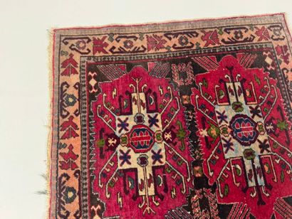 Small hand-knotted wool rug with stylized...