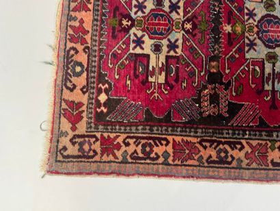 Small hand-knotted wool rug with stylized...