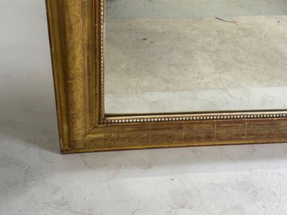 Wood and gilded stucco mirror decorated with...