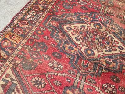 Hand-knotted wool rug with geometric motifs.
200...