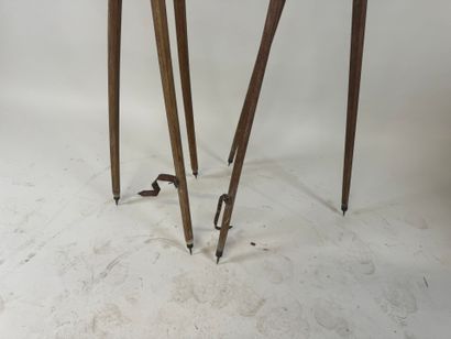 Two wooden tripods, one with a telescope...