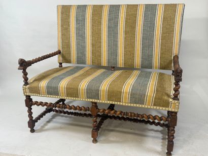 Molded and twisted wood bench, the arms decorated...