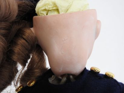 Little doll with bisque head, fixed eyes,...