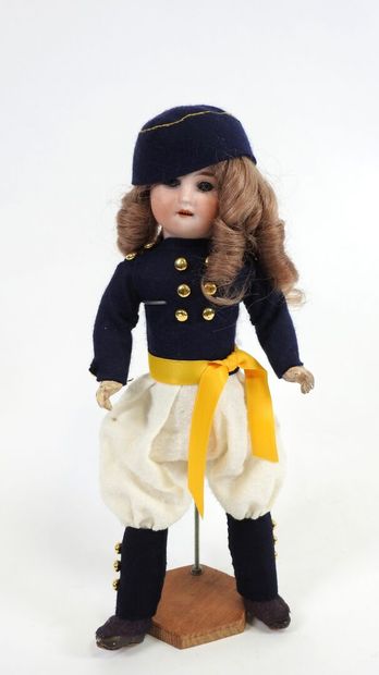 Little doll with bisque head, fixed eyes,...