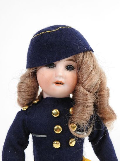 Little doll with bisque head, fixed eyes,...