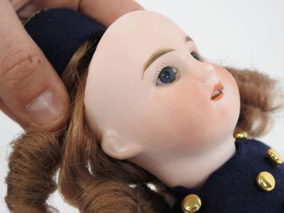 Little doll with bisque head, fixed eyes,...