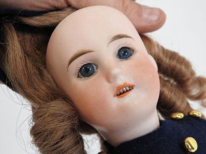 Little doll with bisque head, fixed eyes,...