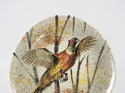 Assiette en faïence à décor d'un faisan.
Diam.:...