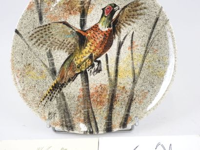 Assiette en faïence à décor d'un faisan.
Diam.:...