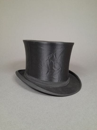 Black satin hat adorned with matching grosgrain...
