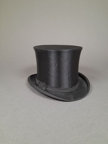 Black satin hat adorned with matching grosgrain...