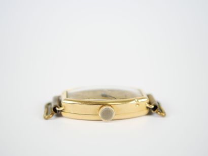 18K yellow gold tonneau-shaped lady's wristwatch...
