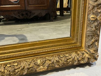 Wood and gilded stucco mirror with foliage...