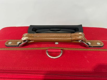 LANCEL.
Large travel case on wheels in red...