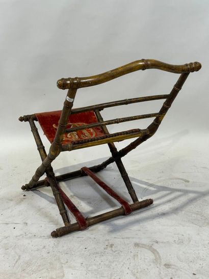 Gilded wood and velvet folding armchair decorated...