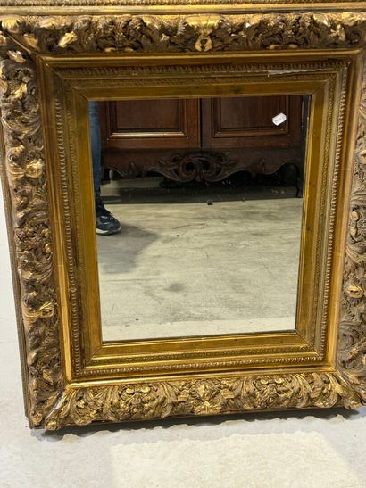 Wood and gilded stucco mirror with foliage...