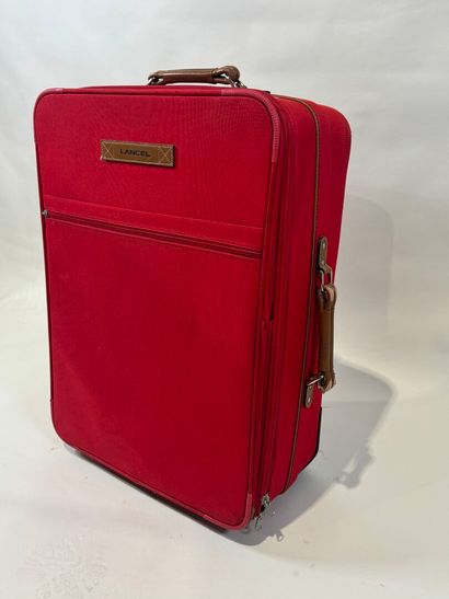 LANCEL.
Large travel case on wheels in red...