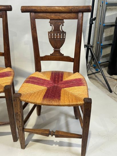 Two pairs of walnut chairs, straw-bottomed...