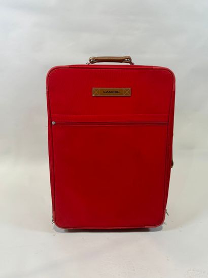 LANCEL.
Large travel case on wheels in red...