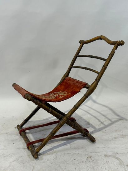 Gilded wood and velvet folding armchair decorated...