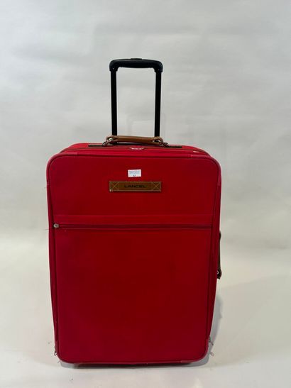 LANCEL.
Large travel case on wheels in red...