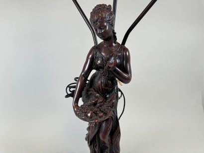 Three-armed resin lamp depicting a woman...