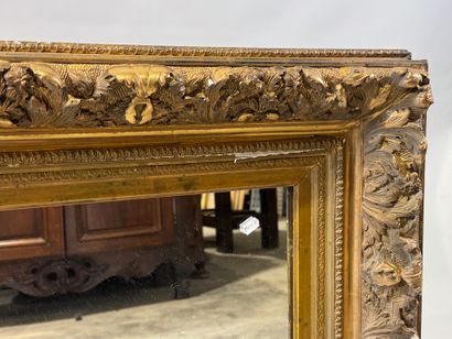 Wood and gilded stucco mirror with foliage...