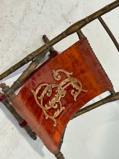 Gilded wood and velvet folding armchair decorated...