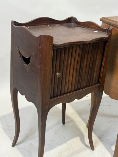 Two wooden bedside tables, one with curtain...