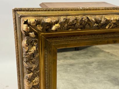 Wood and gilded stucco mirror with foliage...