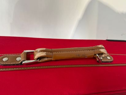 LANCEL.
Large travel case on wheels in red...
