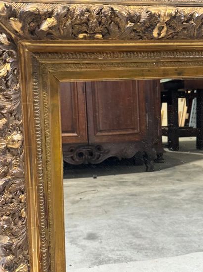 Wood and gilded stucco mirror with foliage...