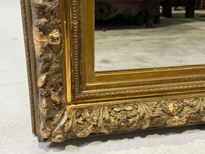 Wood and gilded stucco mirror with foliage...