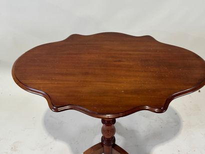 Wooden pedestal table with tilted top.
72...