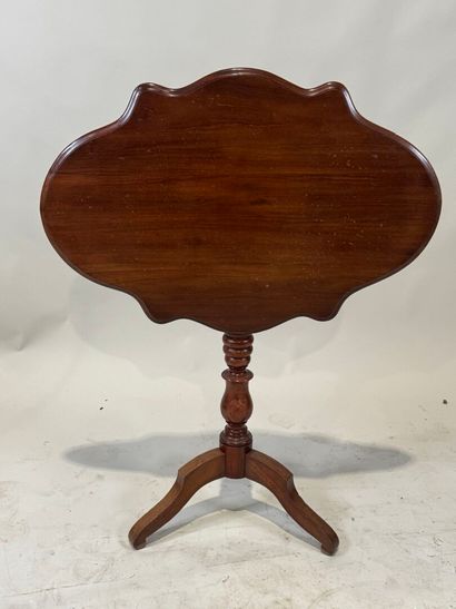 Wooden pedestal table with tilted top.
72...