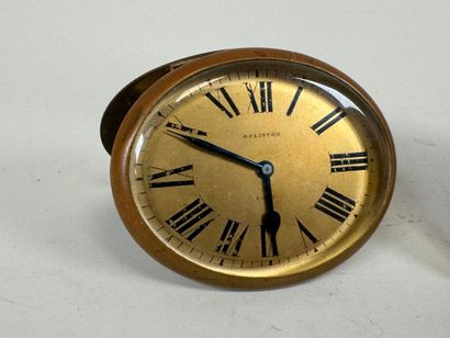 Two brass and glass alarm clocks, one 