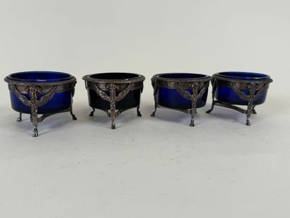 Suite of four salt cellars with solid silver...