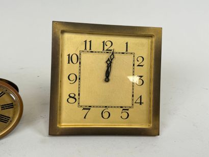 Two brass and glass alarm clocks, one 