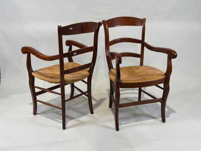 Pair of cherrywood armchairs, straw seat.
20th...