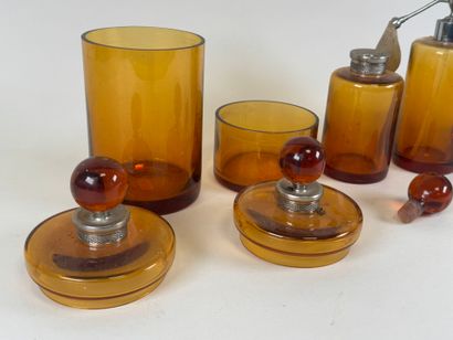 Colored glass and metal toilet set including...