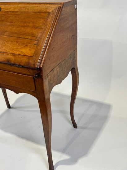 Small wooden sloping desk opening with a...