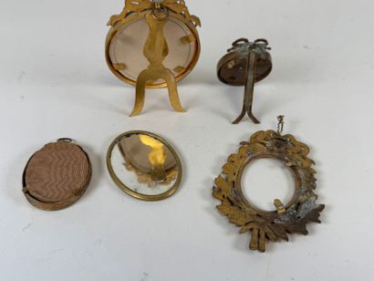 Four small brass picture frames, three with...