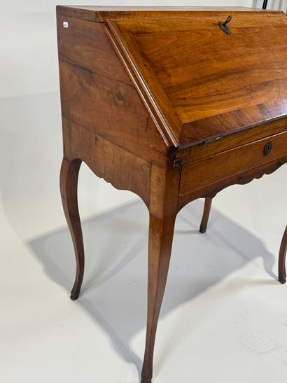 Small wooden sloping desk opening with a...