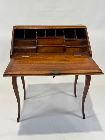 Small wooden sloping desk opening with a...